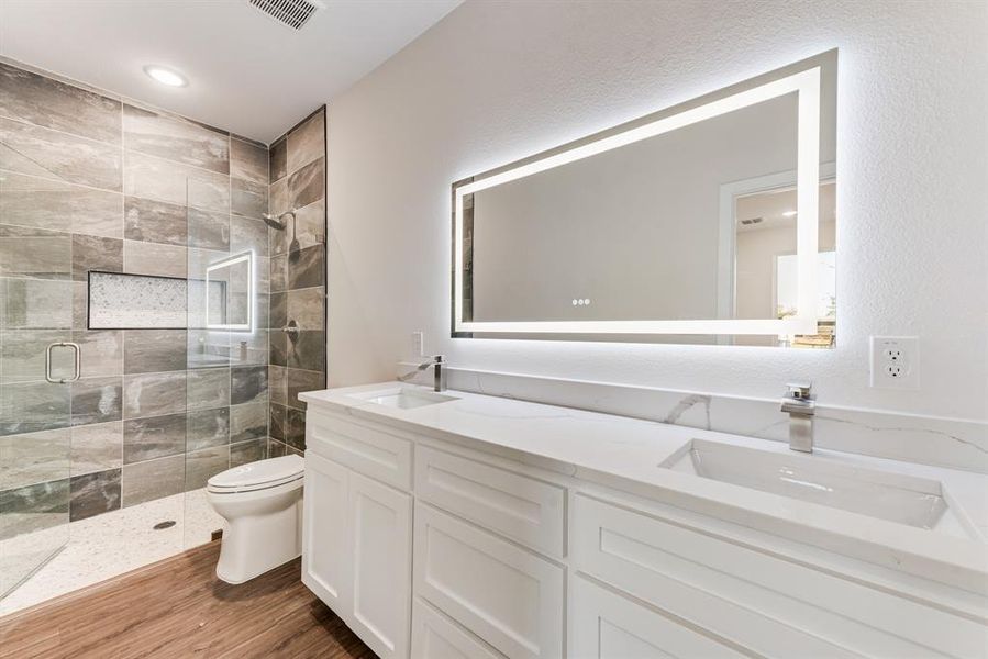 Bathroom with walk in shower, wood-type flooring, vanity, and toilet