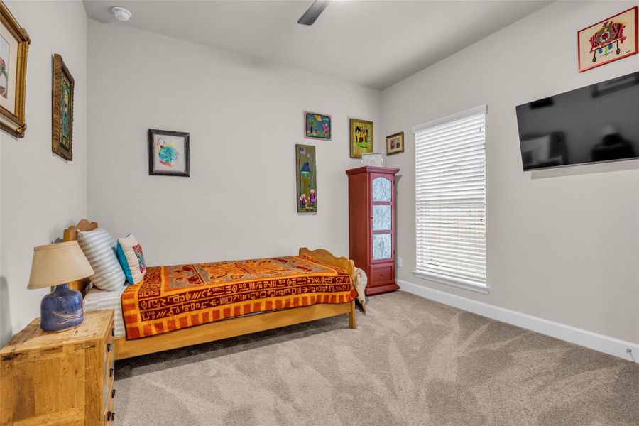 Secondary bedroom with 2" blinds and ceiling fan. Secondary bedroom with 2" blinds and ceiling fan.