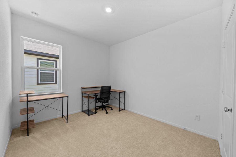 One of the additional bedrooms is being used as a home office.