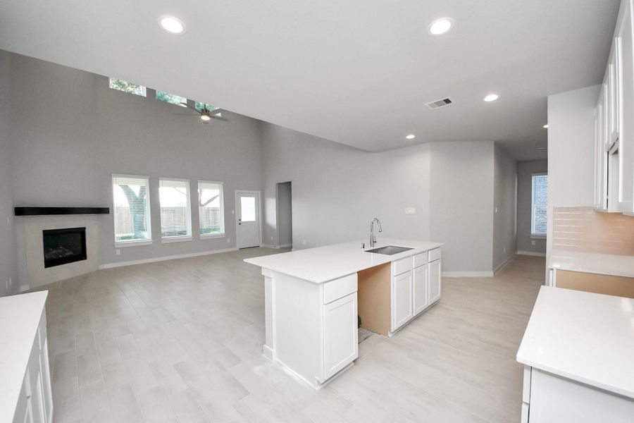 All of this overlooks your expansive family room, creating a perfect space for culinary delights and family gatherings. Sample photo of completed home with similar floor plan. Actual colors and selections may vary.