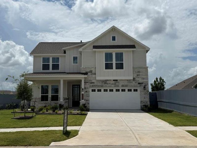 Front exterior of a new home in Fulshear Lakes, Fulshear, TX, highlighting curb appeal (Image 2). Front exterior of a new home in Fulshear Lakes, Fulshear, TX, highlighting curb appeal (Image 2).