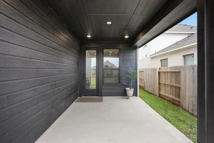 This all black paneled covered patio has a gas connection to build in a outdoor kitchen.