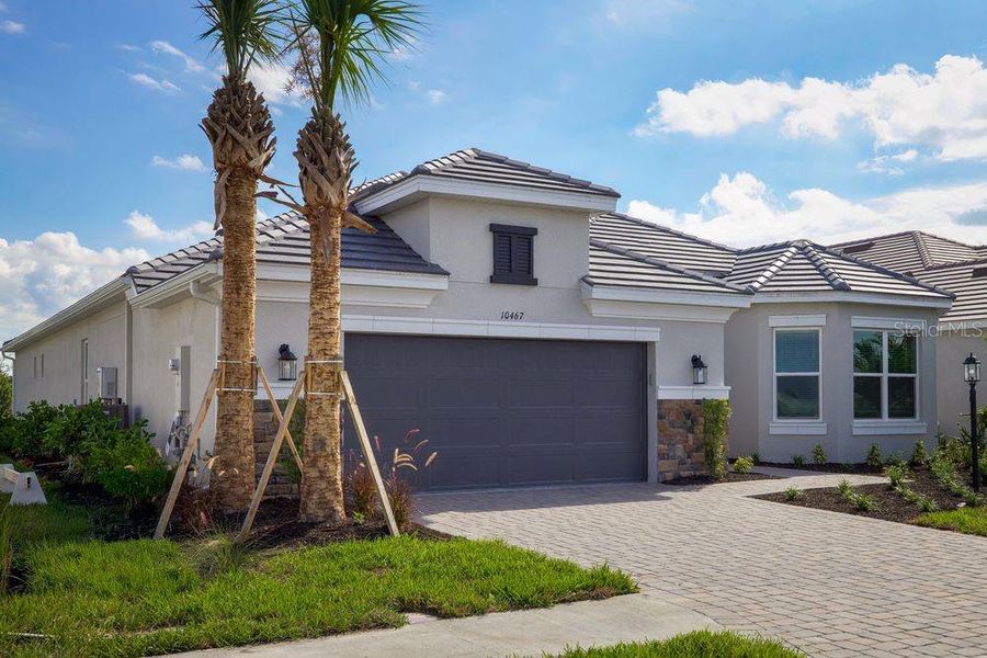 Front exterior of a new home in Esplanade at Skye Ranch, Sarasota, FL, highlighting curb appeal (Image 26).