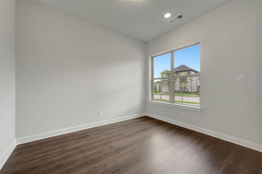 Unfurnished room featuring dark wood-style floors and recessed lighting