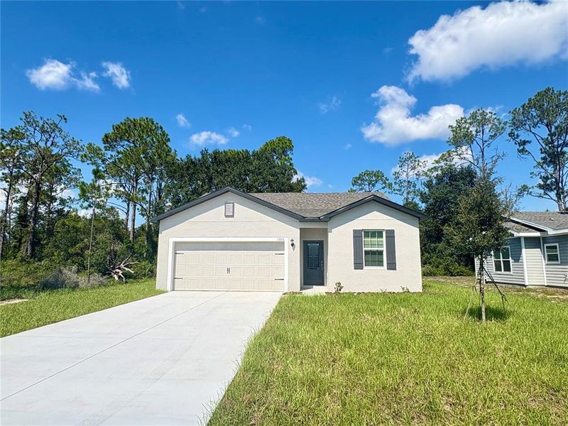 Front exterior of a new home in Poinciana, Poinciana, FL, highlighting curb appeal (Image 16).