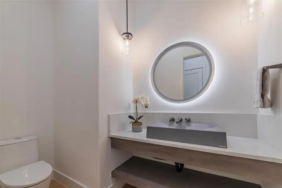 Half bathroom featuring vanity and toilet