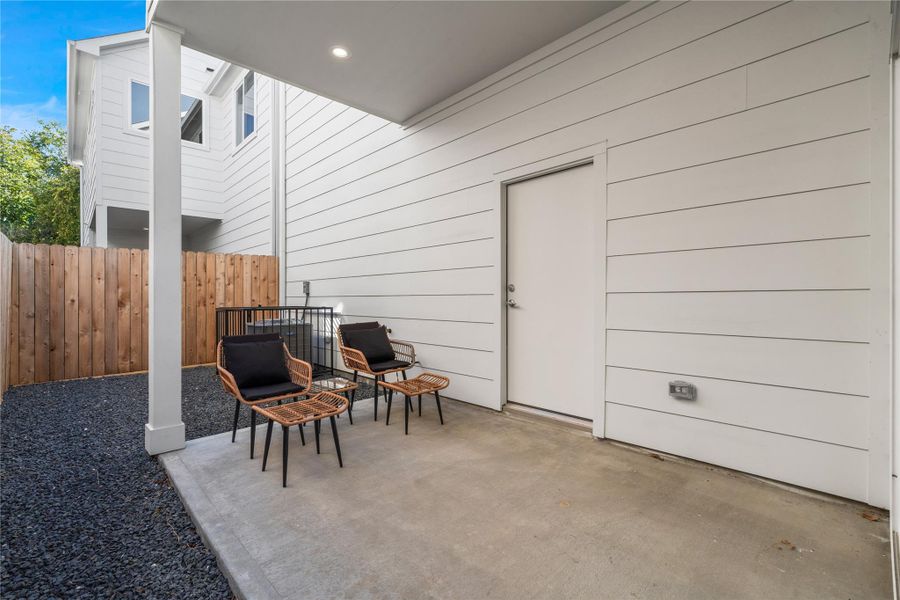 Covered back patio ideal for unwinding after a long day or hosting weekend BBQs with family & friends, an inviting extension of your living space.
