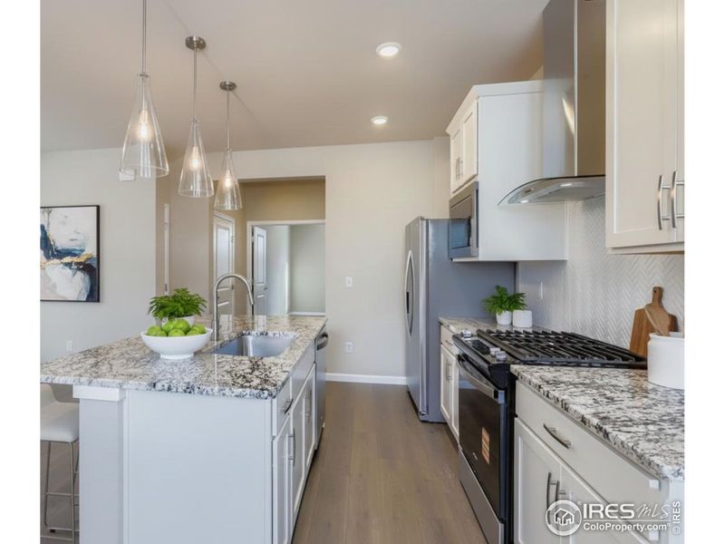 Gleaming granite with maple white soft-close cabinetry.
