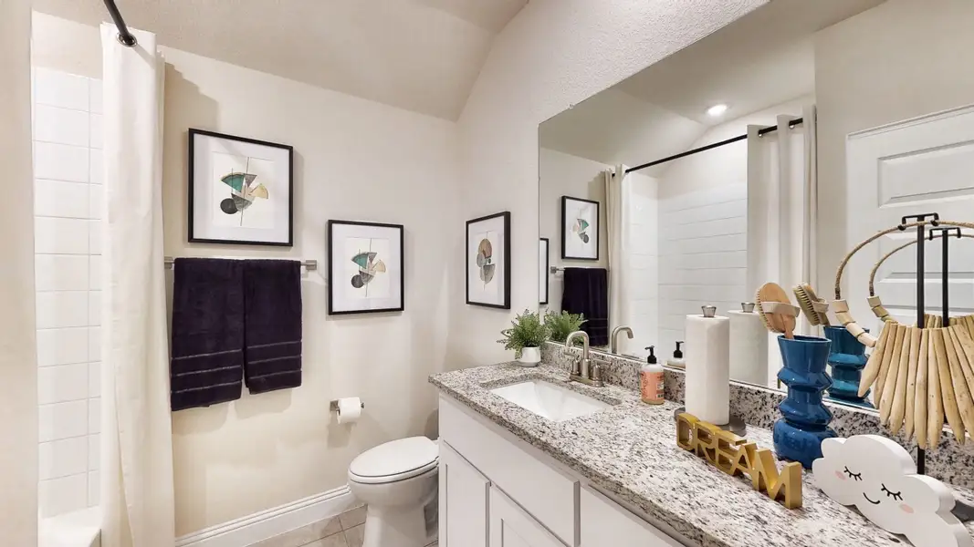A bathroom with a large mirror.