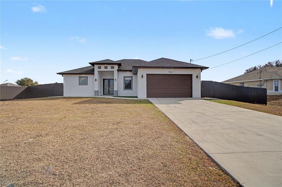 Front exterior of a new home in , Lehigh Acres, FL, highlighting curb appeal (Image 24).
