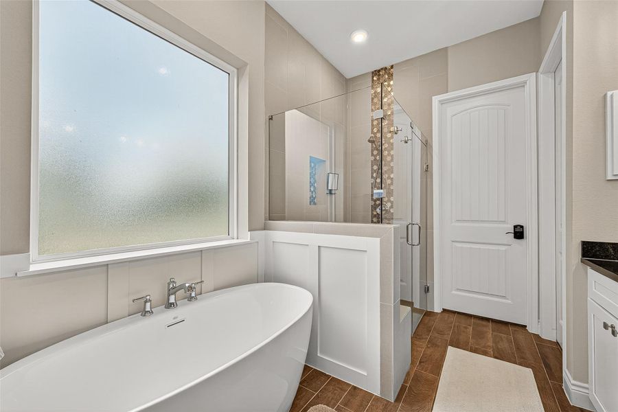 Freestanding tub paired with an oversized walk-in shower accented by custom tile detailing. Freestanding tub paired with an oversized walk-in shower accented by custom tile detailing.