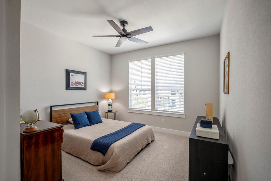 This spacious upstairs guest suite offers neutral carpet, large windows, a walk-in closet and ensuite access to a full bathroom, with plenty of room to settle in and feel at home.
