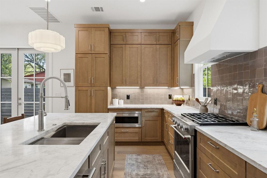 An inviting kitchen with a substantial island and gleaming countertops for culinary endeavors.