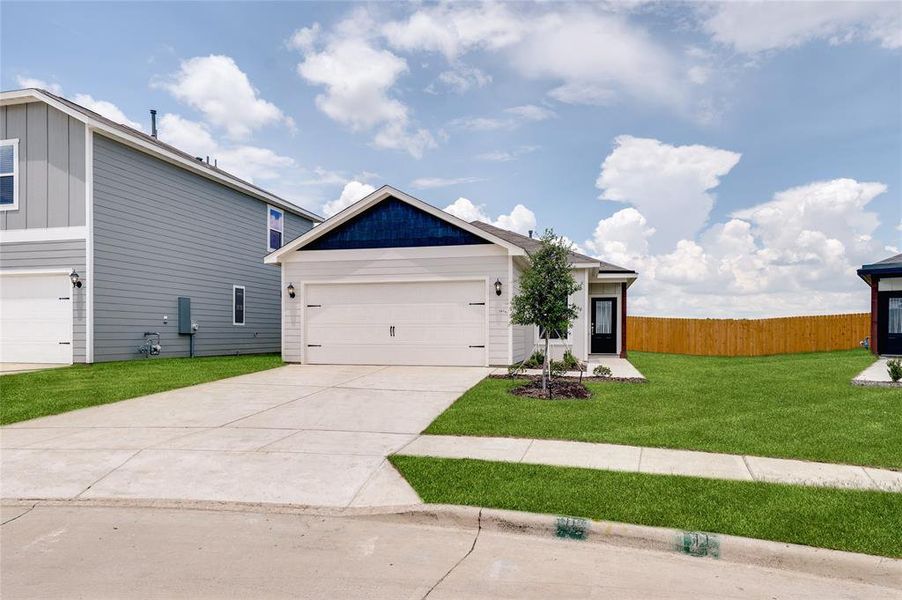View of front facade with concrete driveway and an attached garage