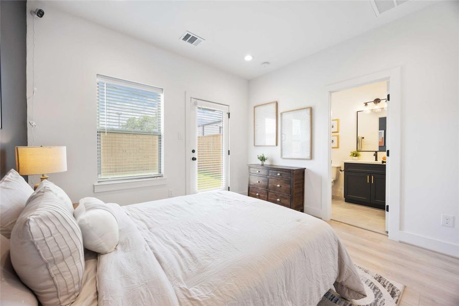 First floor secondary bedroom with full en-suite bath. Photo is from the model home. Finishes and specifications may vary.