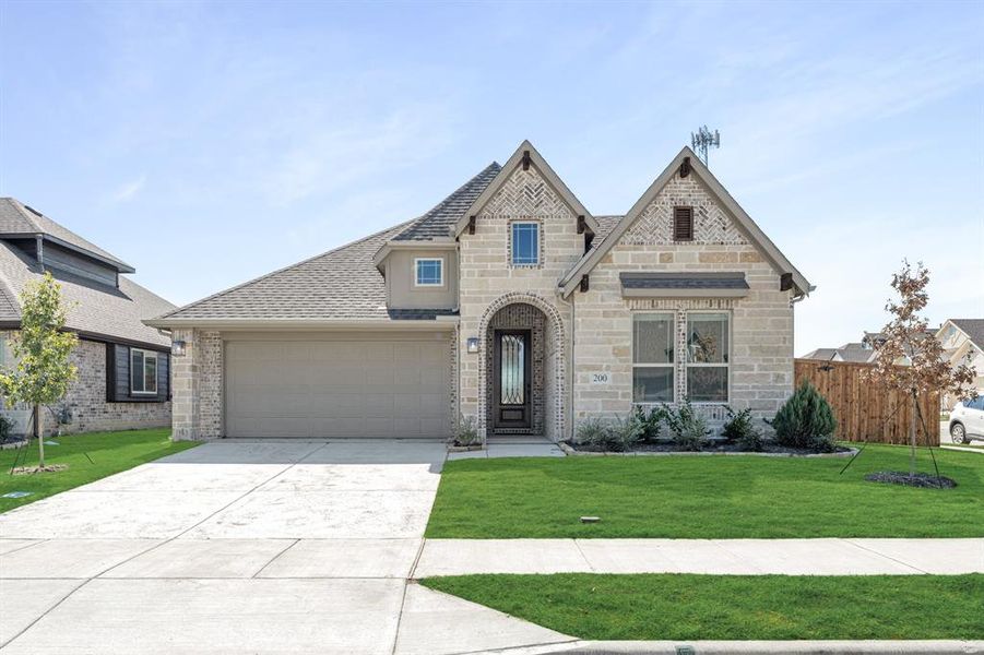 Front exterior of a new home in East Oak Creek 50-55, Commerce, TX, highlighting curb appeal (Image 20).