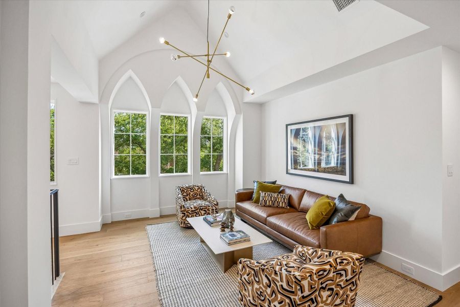 Upstairs Gameroom with vaulted ceiling, triplet of Lancet style windows and handsome chandelier Upstairs Gameroom with vaulted ceiling, triplet of Lancet style windows and handsome chandelier