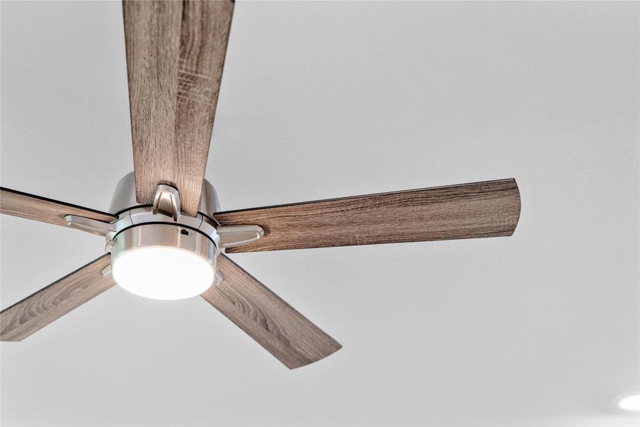 This modern ceiling fan combines industrial flair with contemporary efficiency, making it a stylish and functional addition to the Family Room.