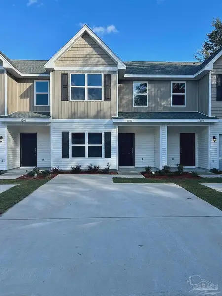 Front exterior of a new home in Lexlee Estates, Pensacola, FL, highlighting curb appeal (Image 1).