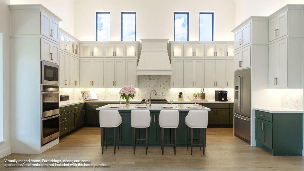 Kitchen featuring green cabinetry, white cabinetry, an island with sink, a breakfast bar, and stainless steel appliances Kitchen featuring green cabinetry, white cabinetry, an island with sink, a breakfast bar, and stainless steel appliances