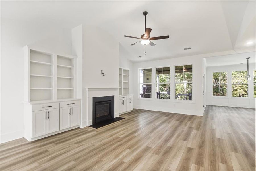 High ceilings and clean plank flooring frame a cla