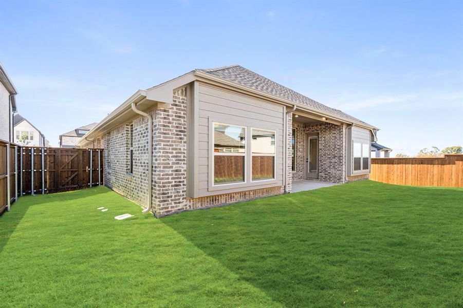 Exterior details and patio area of a home in Creekview Meadows, Pilot Point (Image 4).