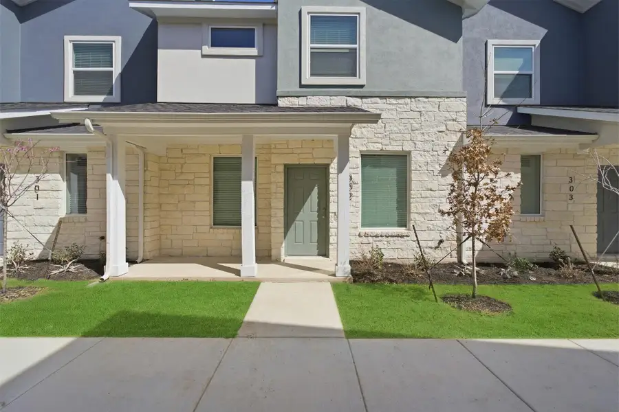 View of front of house featuring stone siding, a porch, a front yard, and stucco siding View of front of house featuring stone siding, a porch, a front yard, and stucco siding