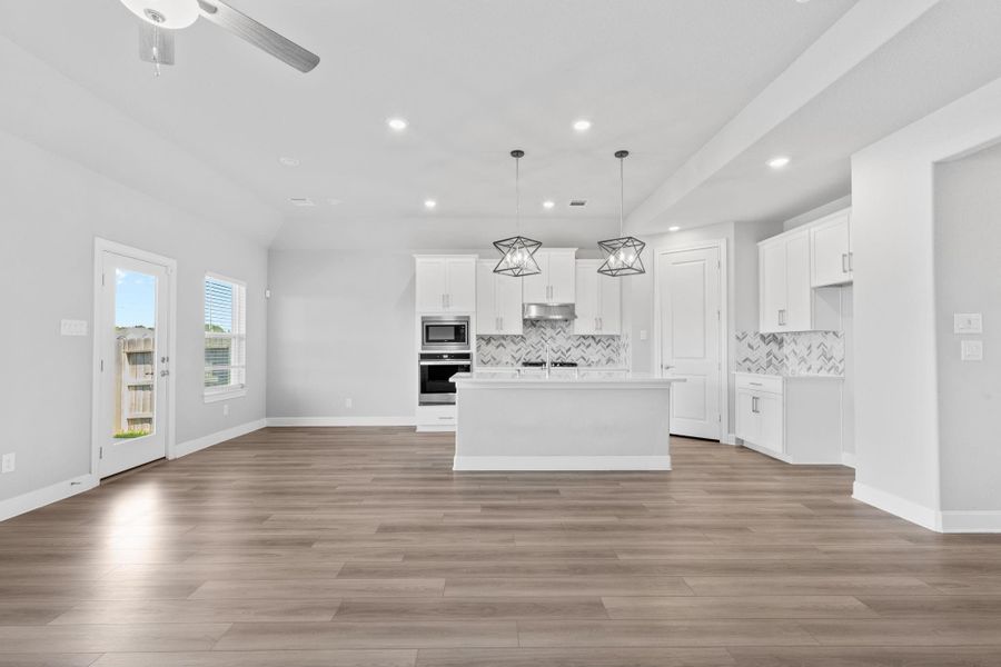 Full view from fireplace of living room, breakfast nook, and kitchen. Full view from fireplace of living room, breakfast nook, and kitchen.