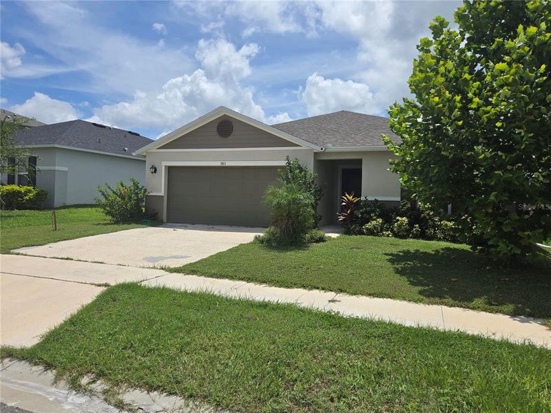Front exterior of a new home in , Winter Haven, FL, highlighting curb appeal (Image 1).