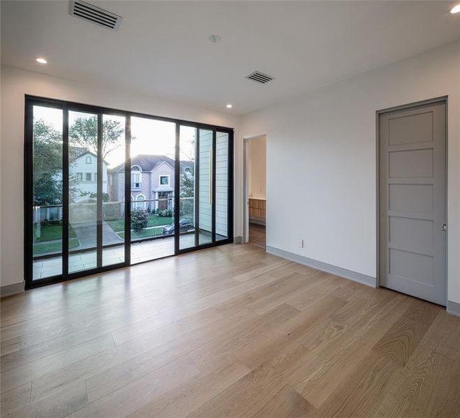 One of the four En-suite secondary bedrooms with walk-in closet and a sliding glass doors leading to a private terrace