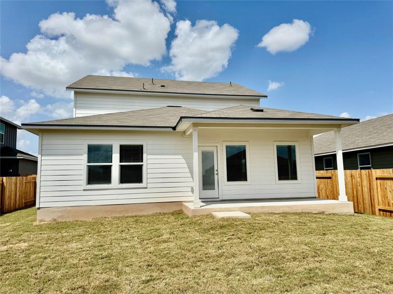 Rear view of property with roof with shingles and a patio area Rear view of property with roof with shingles and a patio area