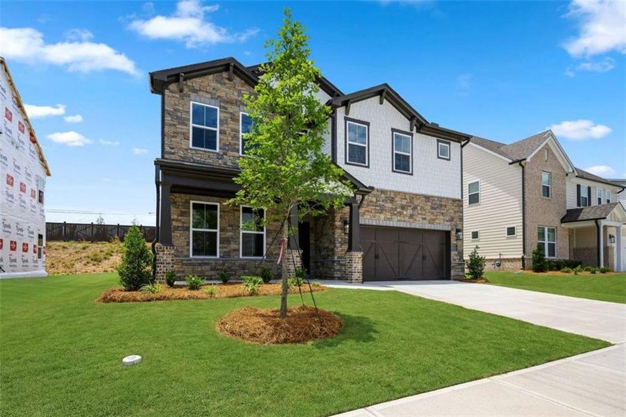 Front exterior of a new home in The Paddocks at Doc Hughes, Buford, GA, highlighting curb appeal (Image 2).