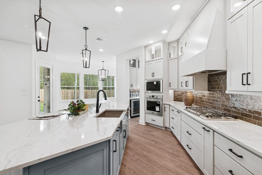 This Kitchen is TRULY a chefs delight!  Impressive and stateley cabinets to ceiling, apron front sink, pull outspice and utensil drawer, soft close doors/drawers & so much more!