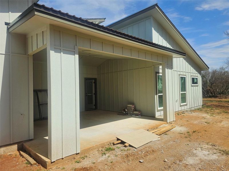 View of home's exterior with board and batten siding and metal roof