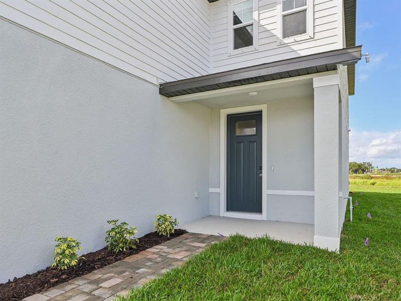 Exterior details and patio area of a home in Oakfield Trails - Signature Series, Parrish (Image 21).