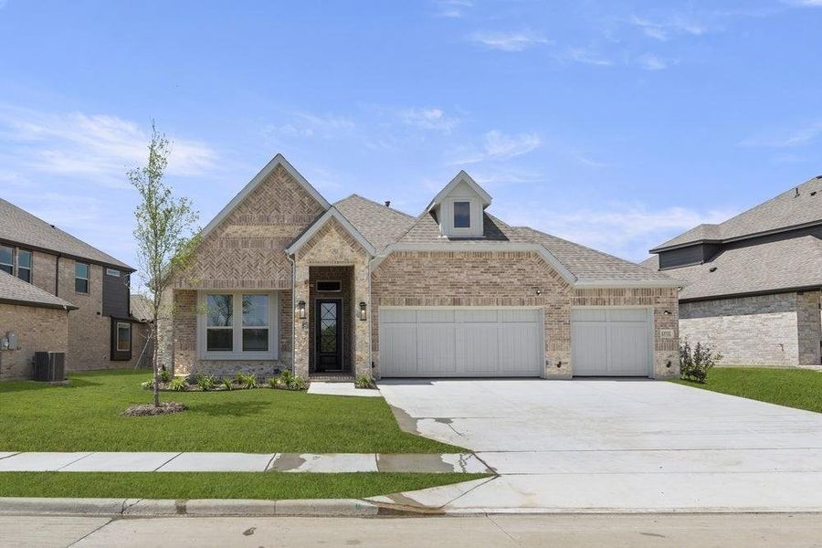Front exterior of a new home in Valencia on The Lake, Little Elm, TX, highlighting curb appeal (Image 2). Front exterior of a new home in Valencia on The Lake, Little Elm, TX, highlighting curb appeal (Image 2).