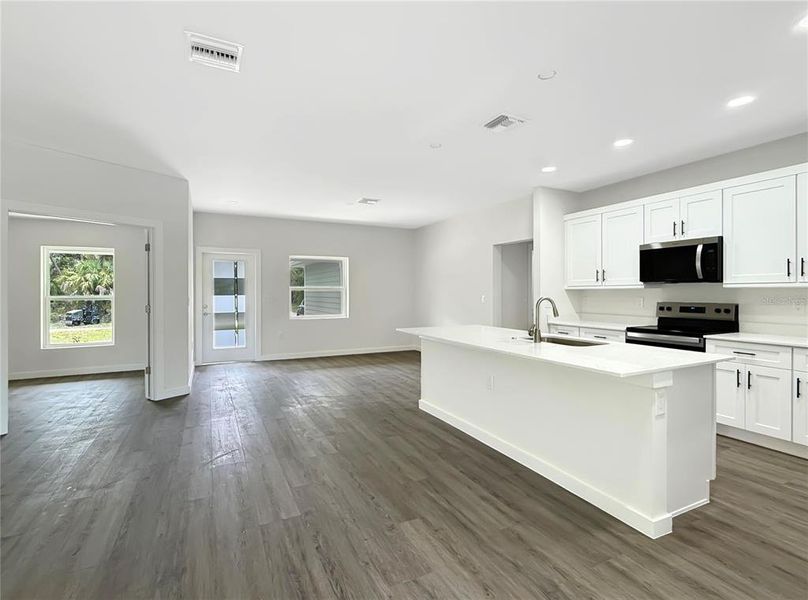 View from Living Area of Kitchen, Dining Area, Front Entry and Den/Flex Space