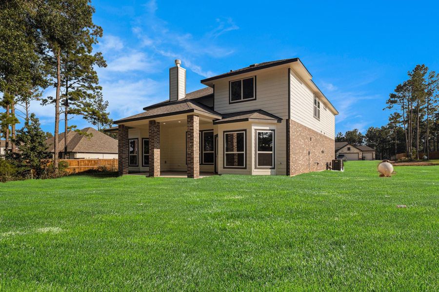 Front exterior of a new home in Deer Pines, Conroe, TX, highlighting curb appeal (Image 15).