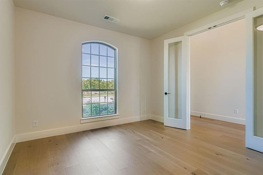 Empty room with light wood-style floors and baseboards