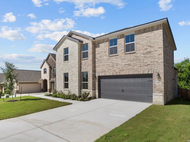 Front exterior of a new home in Ladera, San Antonio, TX, highlighting curb appeal (Image 24).