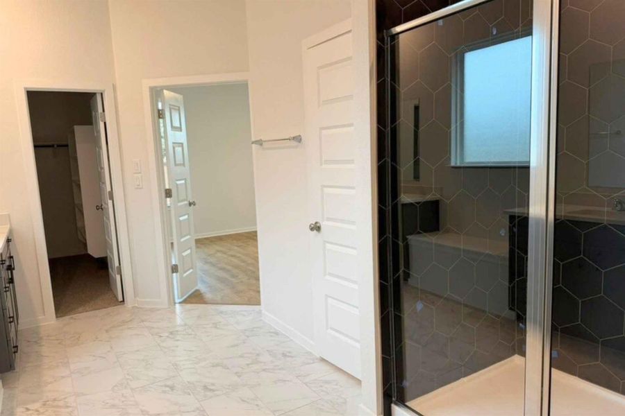 Full bathroom with vanity, a shower stall, and light marble finish floors