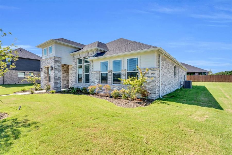 Front exterior of a new home in Ten Mile Creek Estates, DeSoto, TX, highlighting curb appeal (Image 15). Front exterior of a new home in Ten Mile Creek Estates, DeSoto, TX, highlighting curb appeal (Image 15).