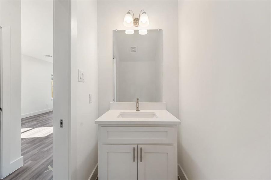 Bathroom with vanity and dark wood-style flooring