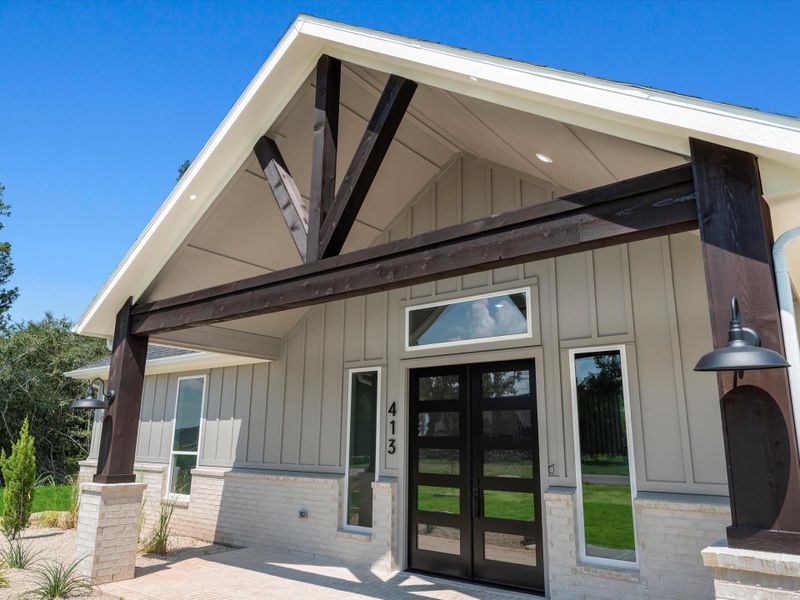 Front view of the home with charming front porch with cozy seating, perfect for enjoying quiet mornings or evening sunsets. Front view of the home with charming front porch with cozy seating, perfect for enjoying quiet mornings or evening sunsets.