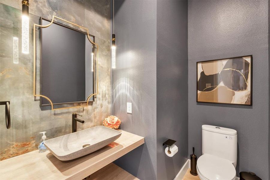 Bathroom with sink, toilet, and hardwood / wood-style flooring