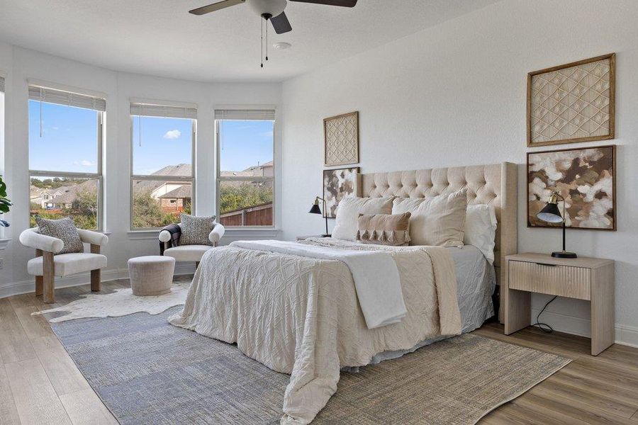 Bedroom with light wood-type flooring and a ceiling fan Bedroom with light wood-type flooring and a ceiling fan