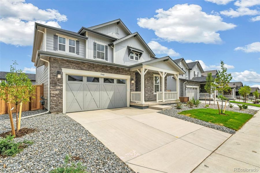 Front exterior of a new home in Windsong, Thornton, CO, highlighting curb appeal (Image 2).