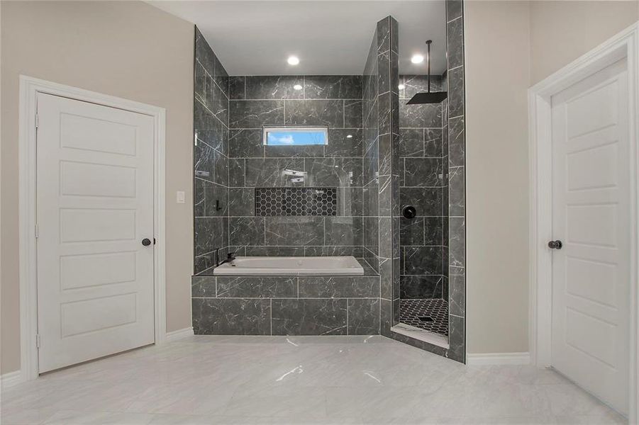 Full bathroom featuring a marble finish shower and a bath Full bathroom featuring a marble finish shower and a bath