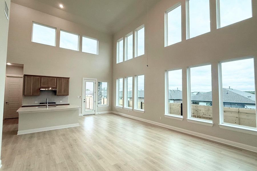 A spacious, airy living area boasts towering ceilings and an abundance of windows, flooding the space with natural light. A spacious, airy living area boasts towering ceilings and an abundance of windows, flooding the space with natural light.