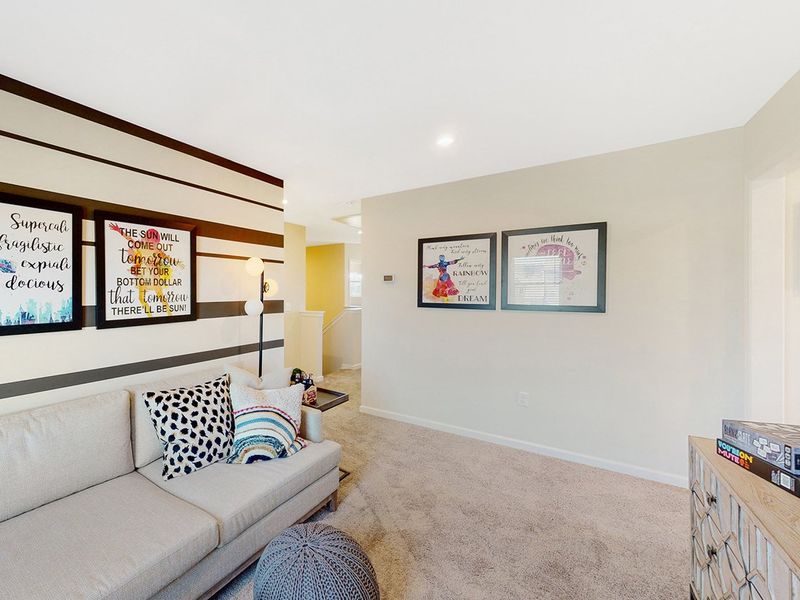 A living room with a couch and a table. A living room with a couch and a table.